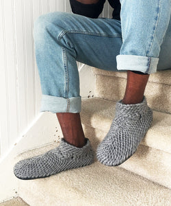 light gray knitted slippers for men with a grippy and durable non slip leather sole. Slipper booties for men with a furry shearling lining. Crochet gray woolen home shoes for men handmade in canada